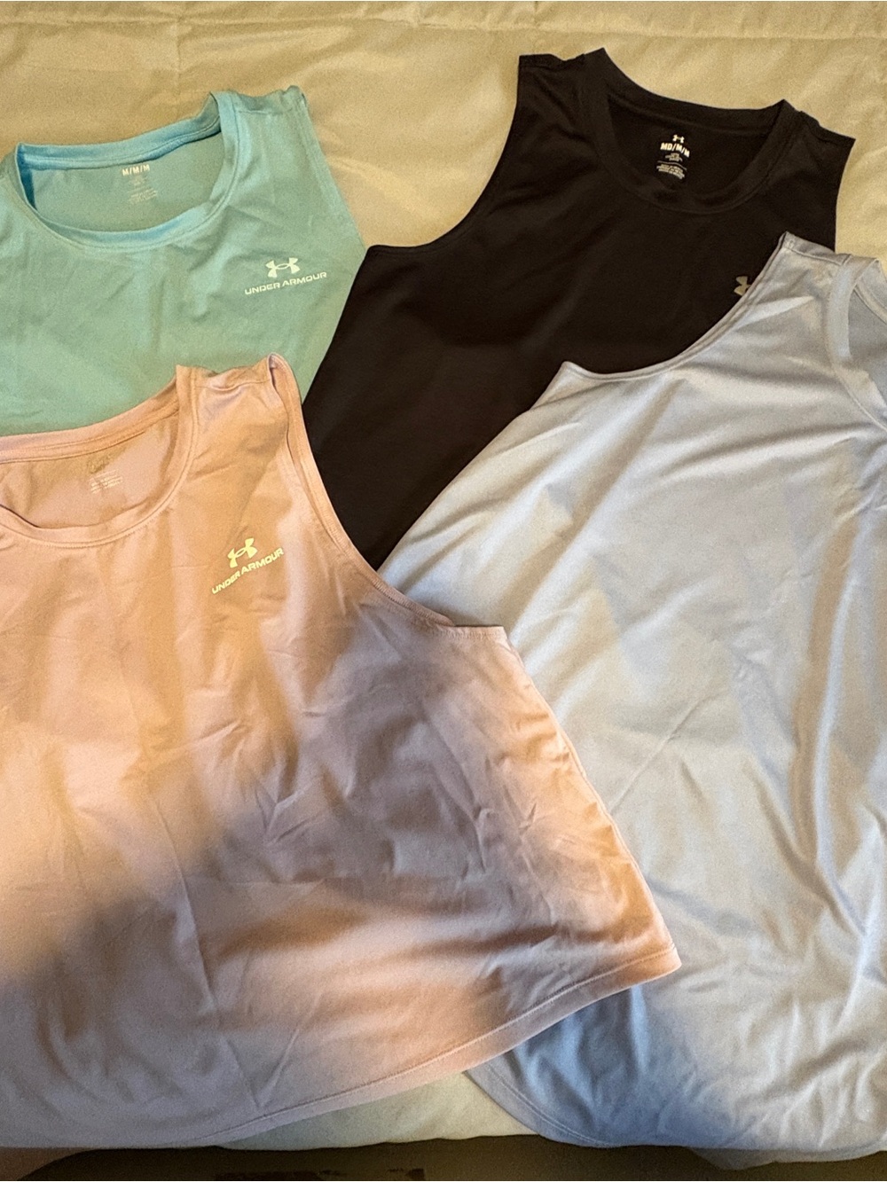 4 Under Armour women’s workout tanks Medium